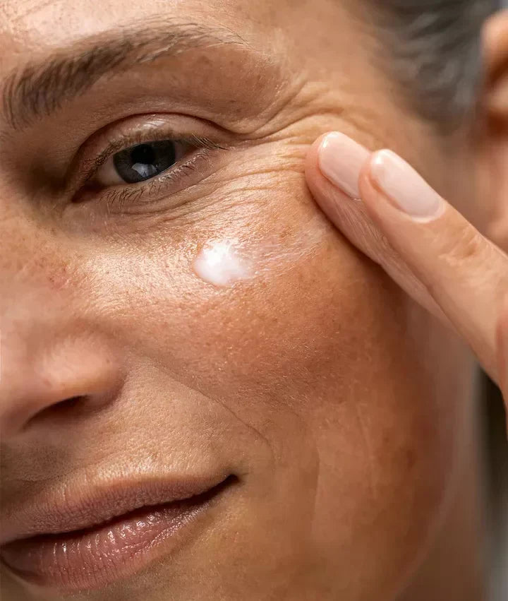 woman putting eye cream on 