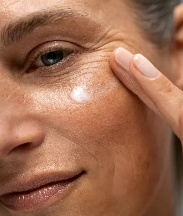 woman putting eye cream on 