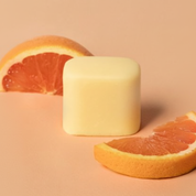 Summer Crush solid organic deodorant on a peach citrus background with no white border